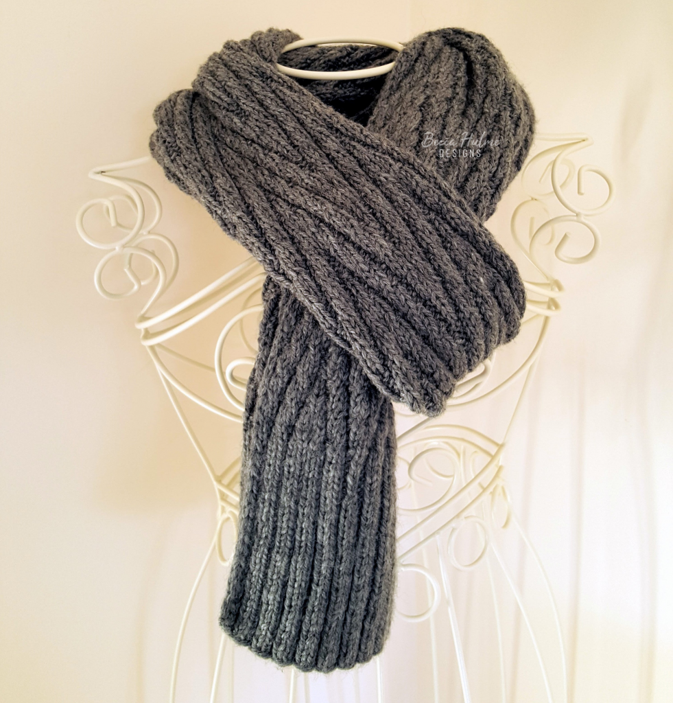 Grey scarf folded in half and worn around the neck of a dressform.